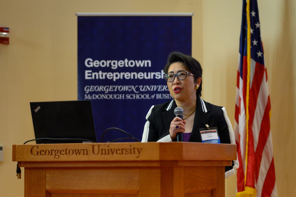  Speaker at podium with flag and banner